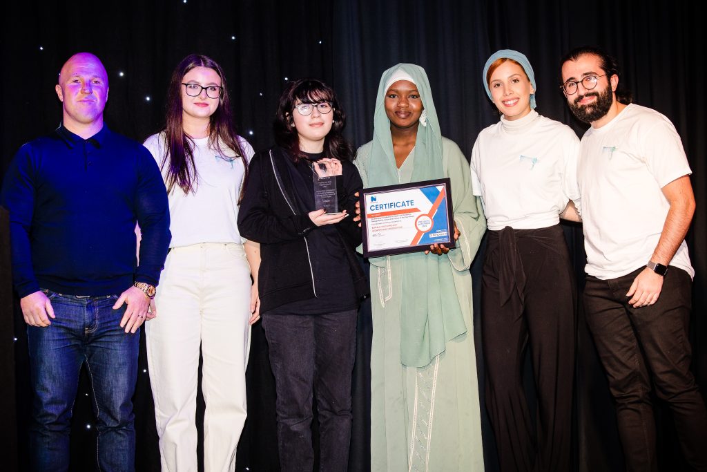 group of people holding a certificate