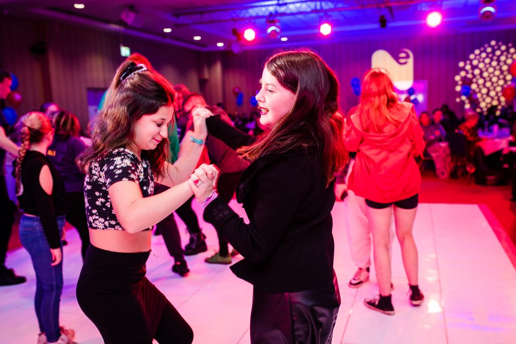 two young girls dancing on a dance floor