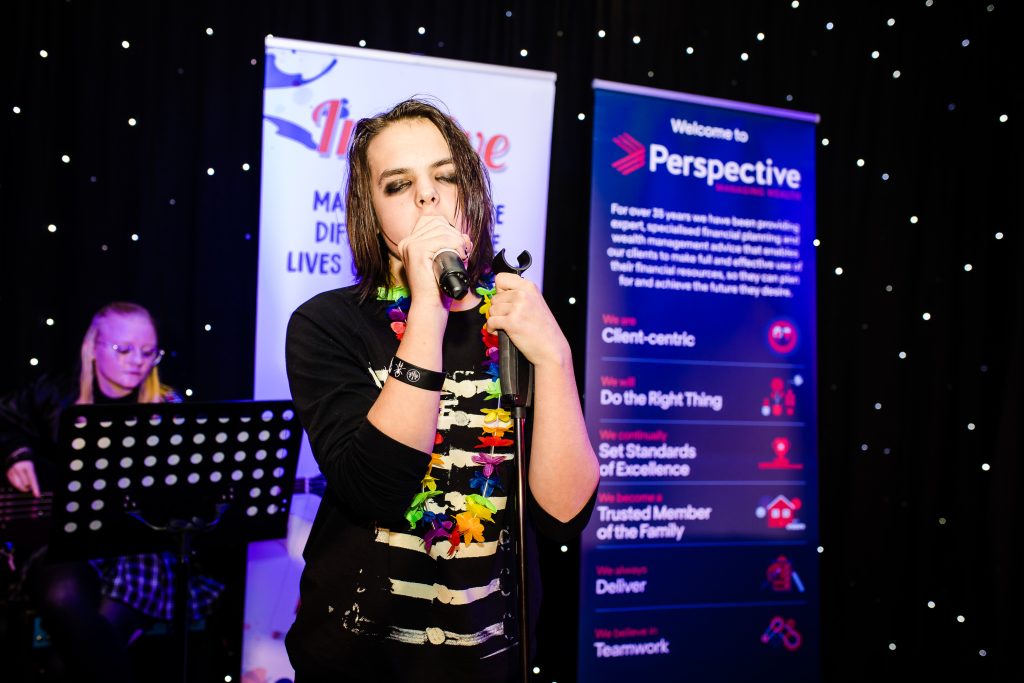 young person singing on stage